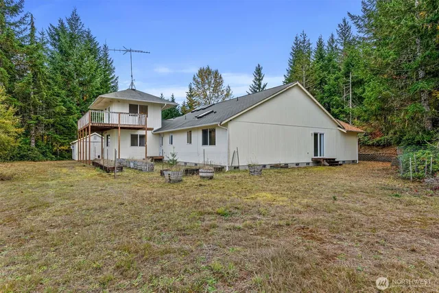 an aerial view of a house with a yard and lake view