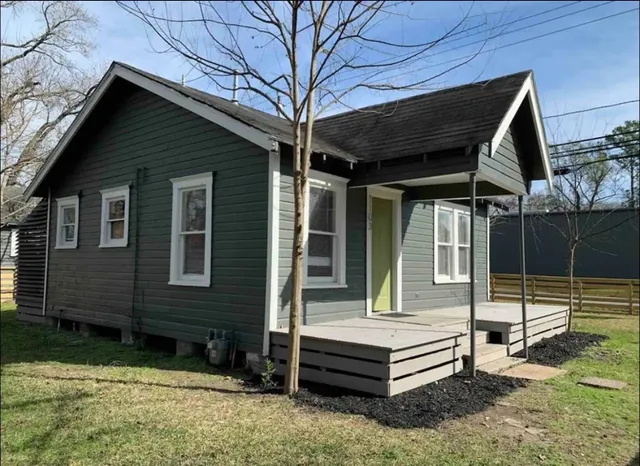 a front view of a house with a garden