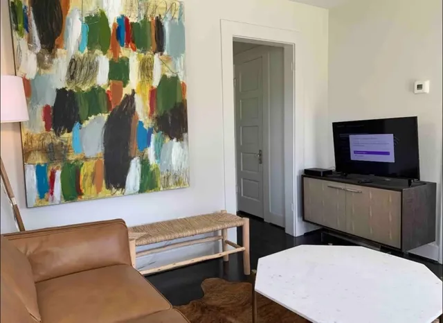 a living room with furniture and a flat screen tv