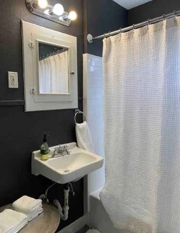 a bathroom with a sink and a mirror