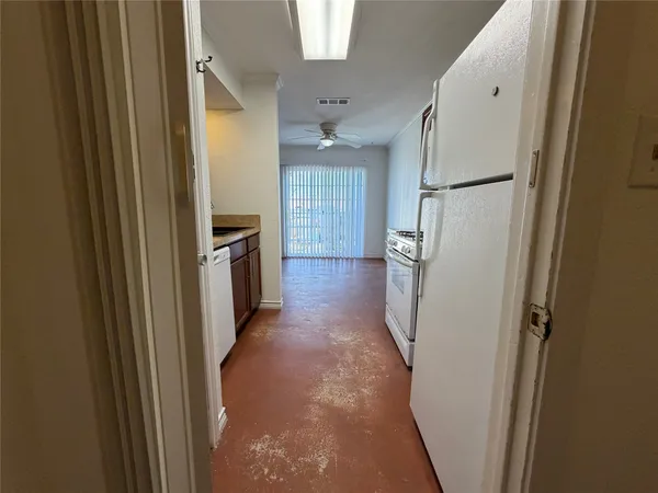 a view of a kitchen from a hallway
