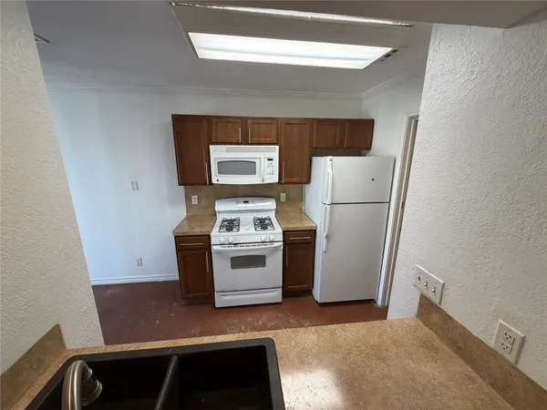 a utility room with refrigerator and stove