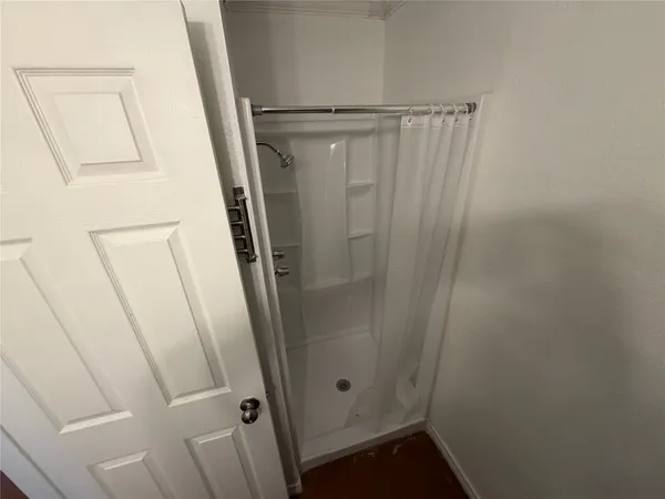 a bathroom with a shower and a mirror