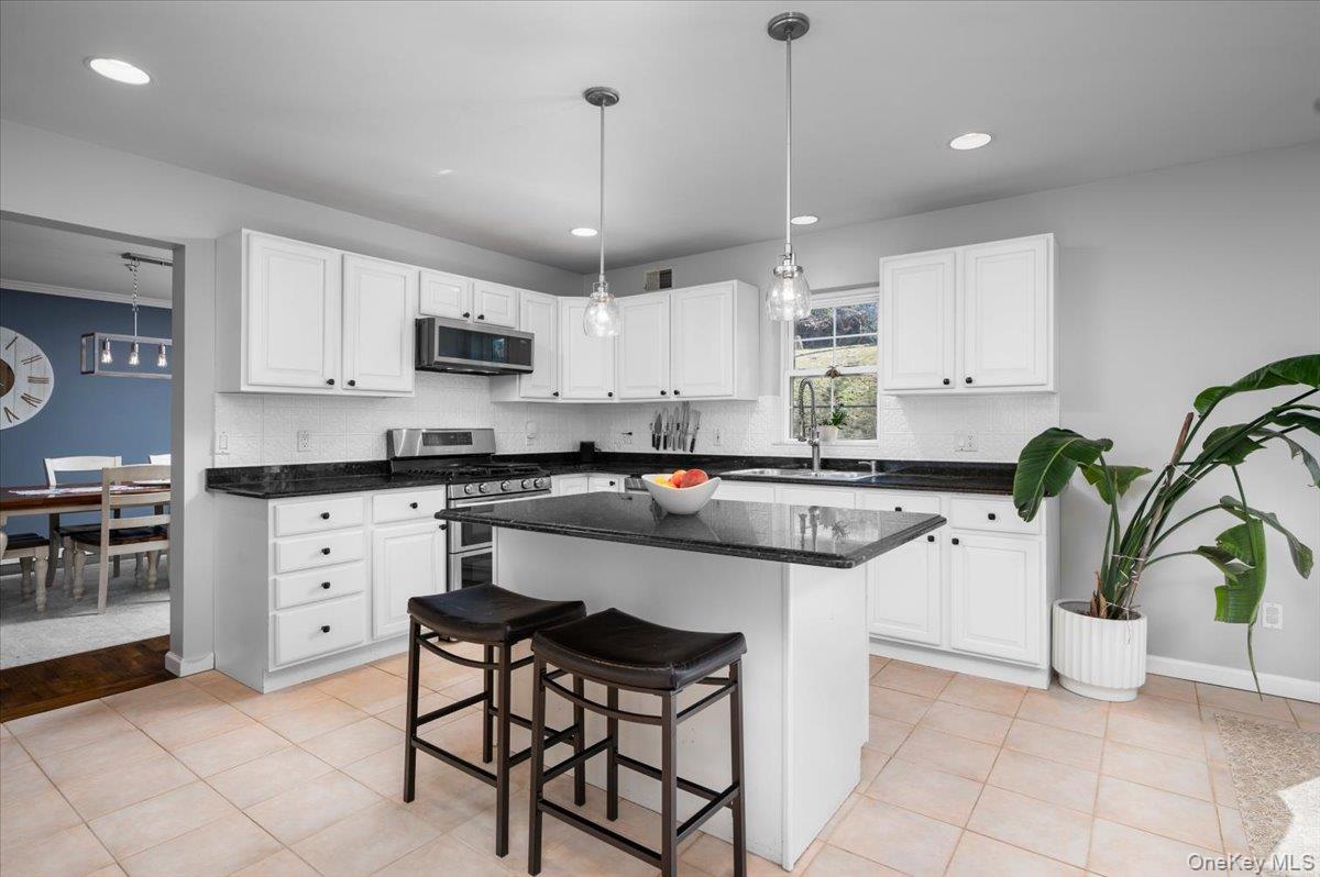 9 Drake Lane White Plains, NY 10607 - Photo 6 of 32 a kitchen with white cabinets and stainless steel appliances