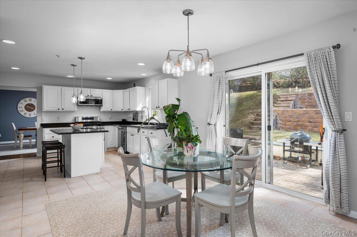 9 Drake Lane White Plains, NY 10607 - Photo 7 of 32 a kitchen with a dining table chairs and stainless steel appliances