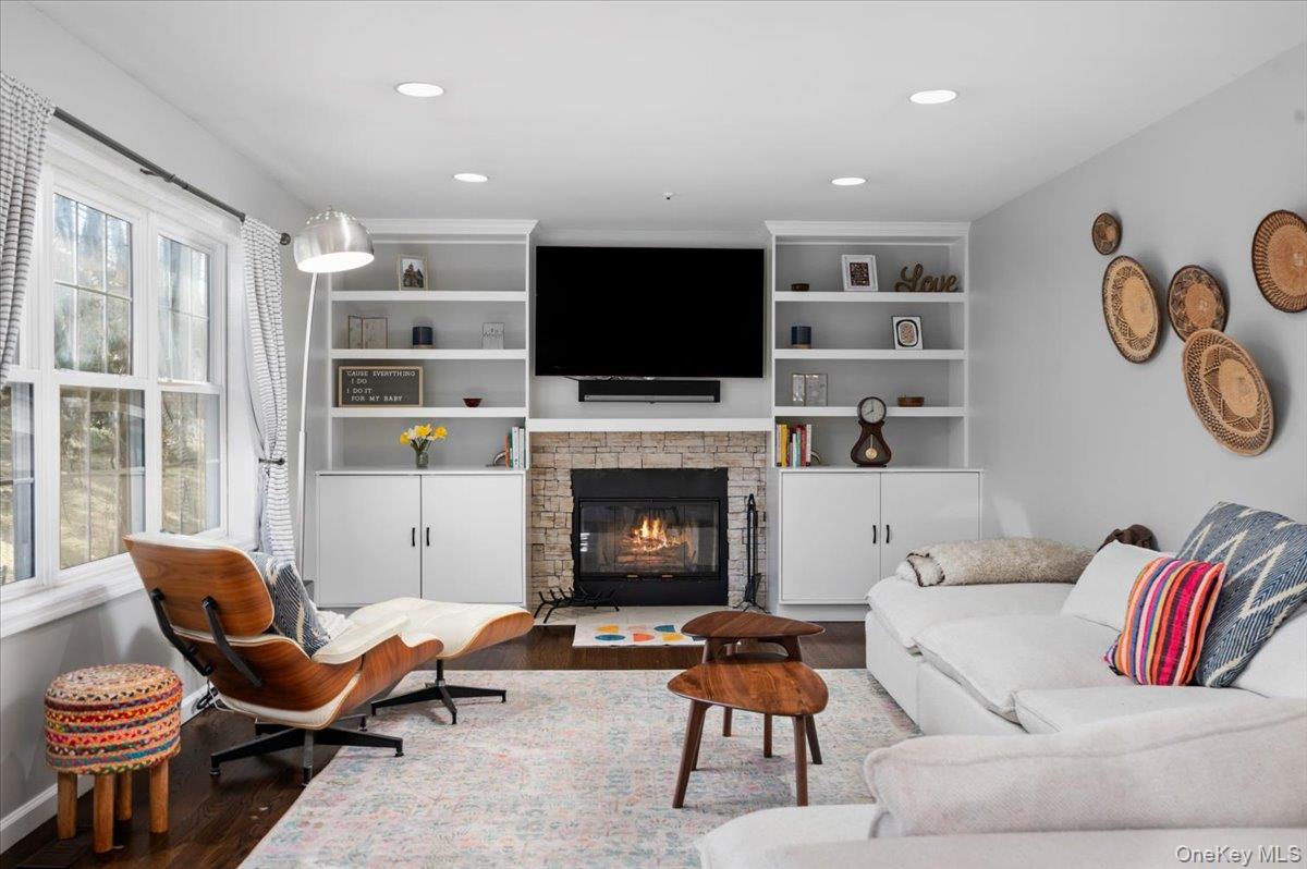 9 Drake Lane White Plains, NY 10607 - Photo 8 of 32 a living room with furniture a flat screen tv and a fireplace