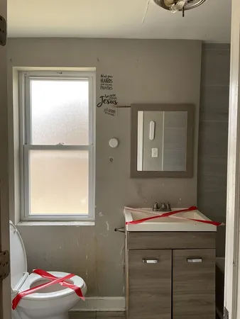 a bathroom with a sink and a window