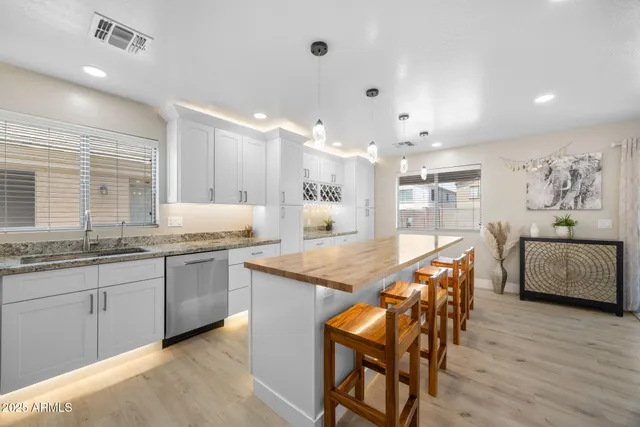 a kitchen that has a sink and a stove