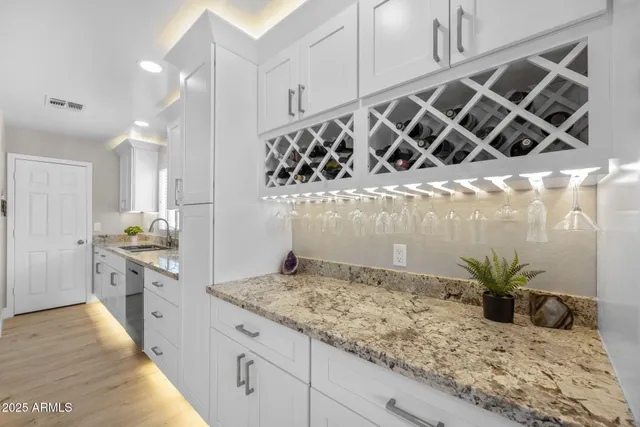 a large kitchen with kitchen island granite countertop a large counter top and stainless steel appliances