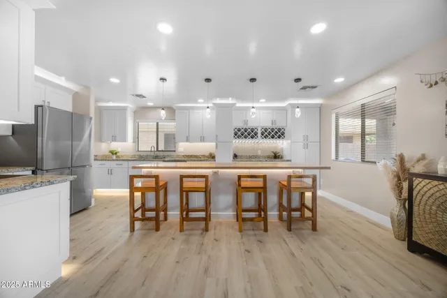 a spacious bedroom with a bed and a chandelier