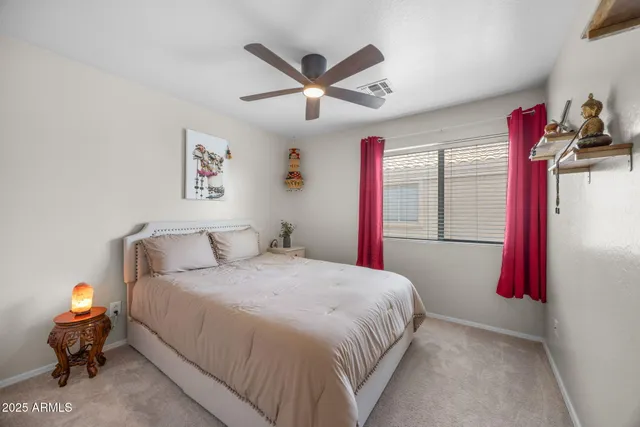 a bedroom with bed and a chandelier