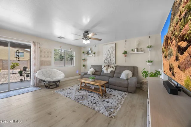 a living room with furniture and kitchen view