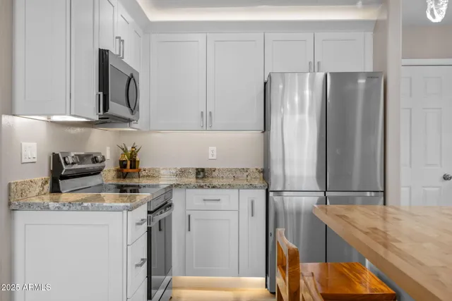 a large kitchen with granite countertop lots of counter space and breakfast area