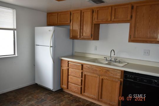 409 South Sunset Street Ridgecrest, CA 93555 - Photo 12 of 19 a kitchen with stainless steel appliances granite countertop a refrigerator and a sink