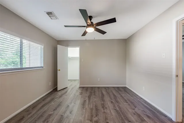 a view of a house with a yard and wooden fence