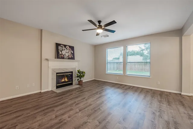 a view of a livingroom with a furniture wooden floor and a ceiling fan