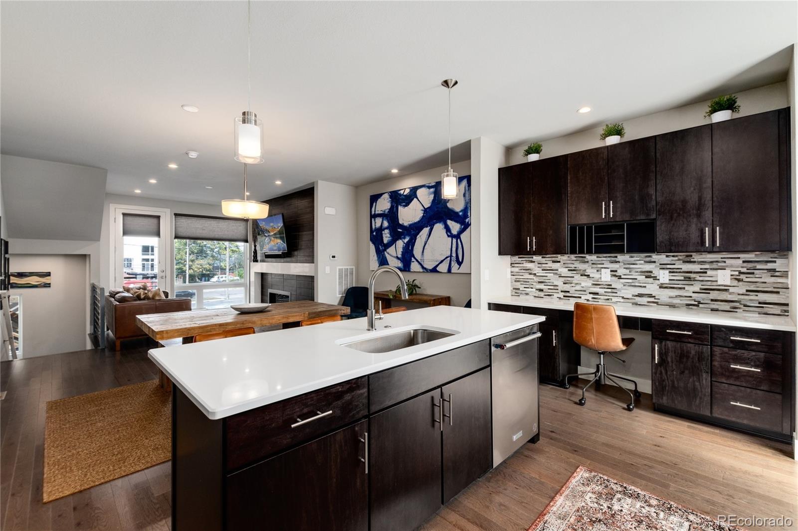 2436 North Washington Street Denver, CO 80205 - Photo 12 of 30 a kitchen with a sink refrigerator and cabinets