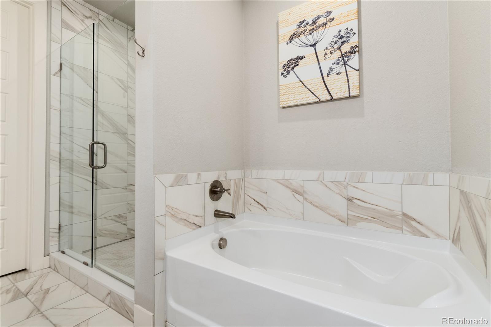 2436 North Washington Street Denver, CO 80205 - Photo 19 of 30 a bathroom with a tub and shower