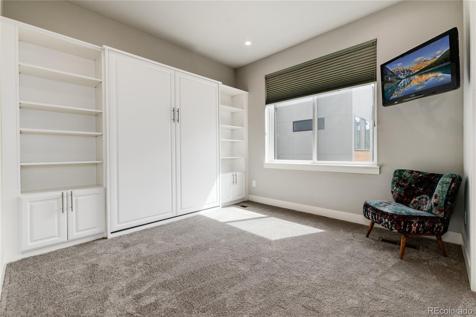 2436 North Washington Street Denver, CO 80205 - Photo 20 of 30 a living room with furniture and a window