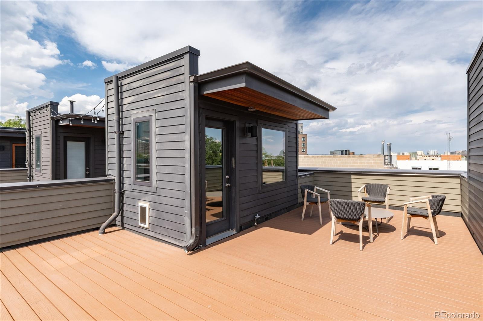 2436 North Washington Street Denver, CO 80205 - Photo 26 of 30 a view of a patio with table and chairs with wooden floor and fence