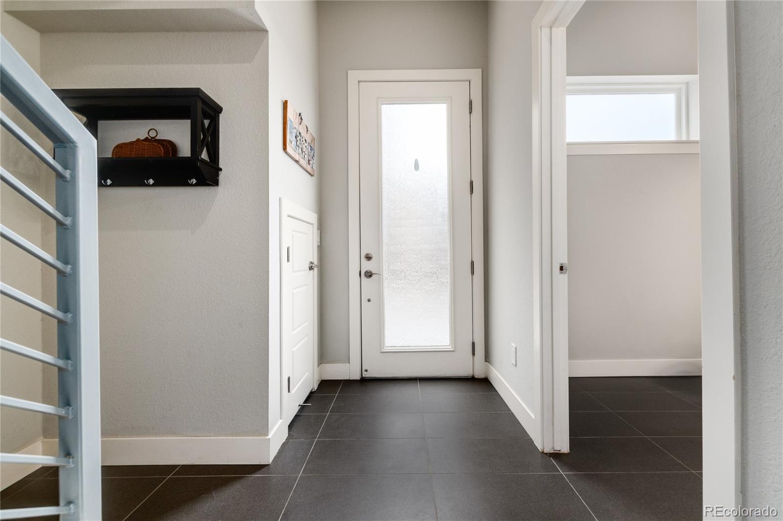 2436 North Washington Street Denver, CO 80205 - Photo 5 of 30 a view of a hallway with wooden floor and entryway