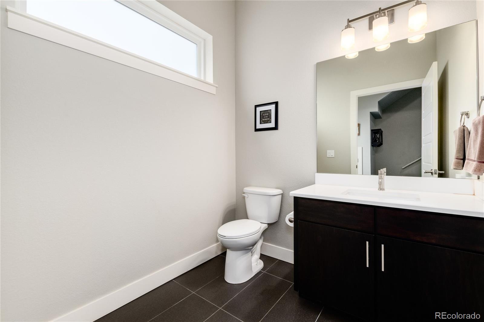 2436 North Washington Street Denver, CO 80205 - Photo 7 of 30 a bathroom with a sink and a toilet