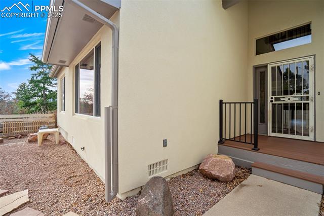 4385 Sandstone Road Monument, CO 80132 - Photo 8 of 50 View of home's exterior featuring stucco siding and a wooden deck