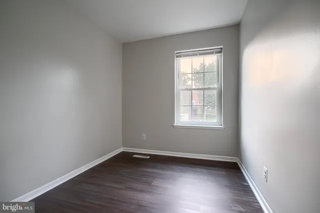 wooden floor and window in an empty room