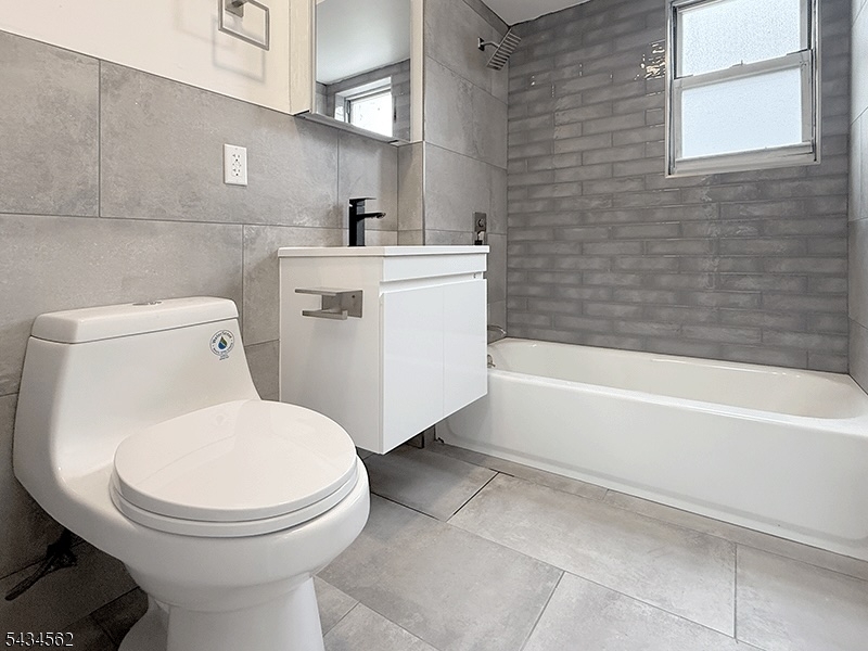 19 Van Rensselear Street, Unit 2 Belleville, NJ 07109 - Photo 6 of 7 a bathroom with a toilet and a bathtub