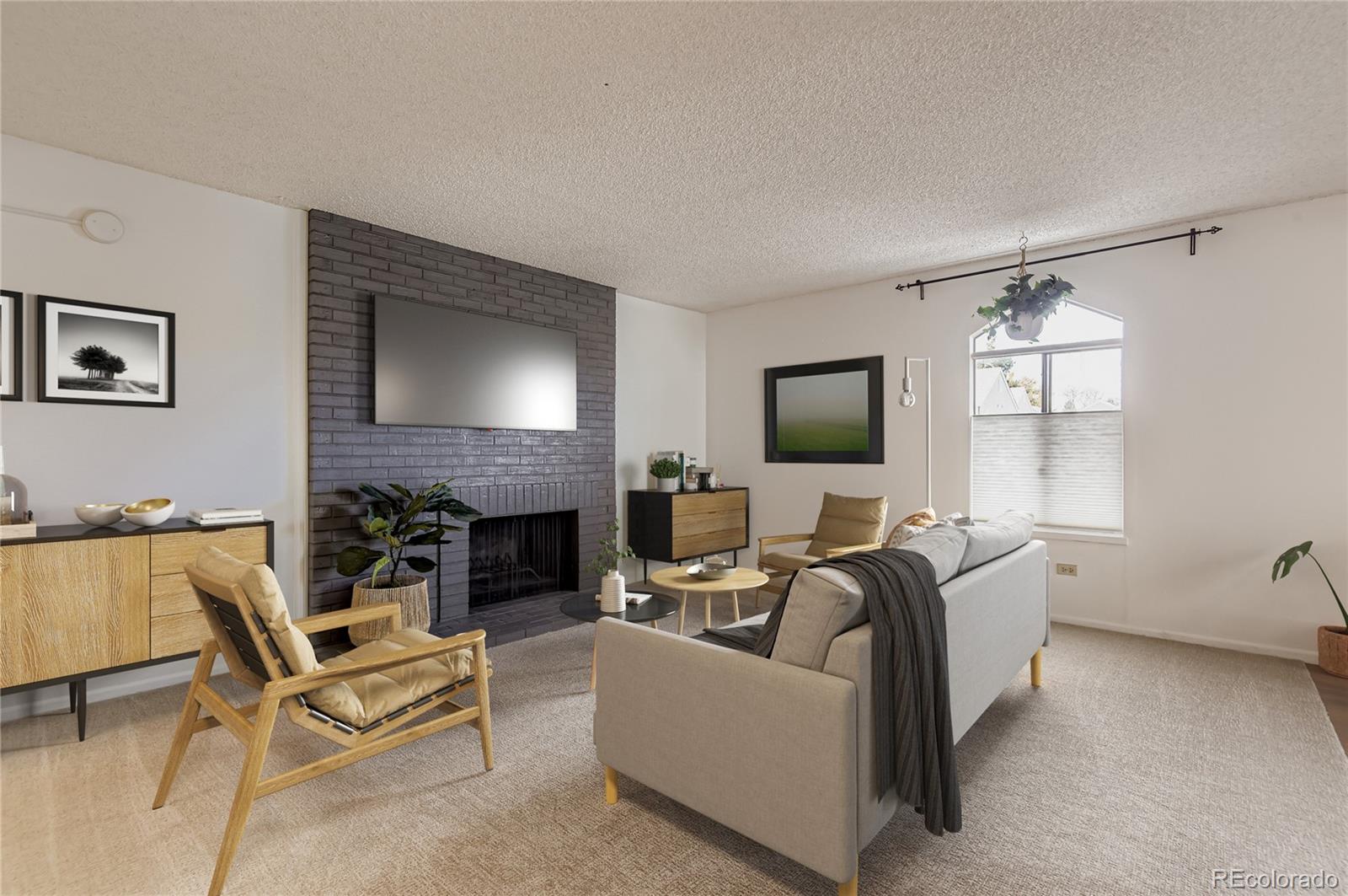 a living room with furniture a fireplace and a flat screen tv