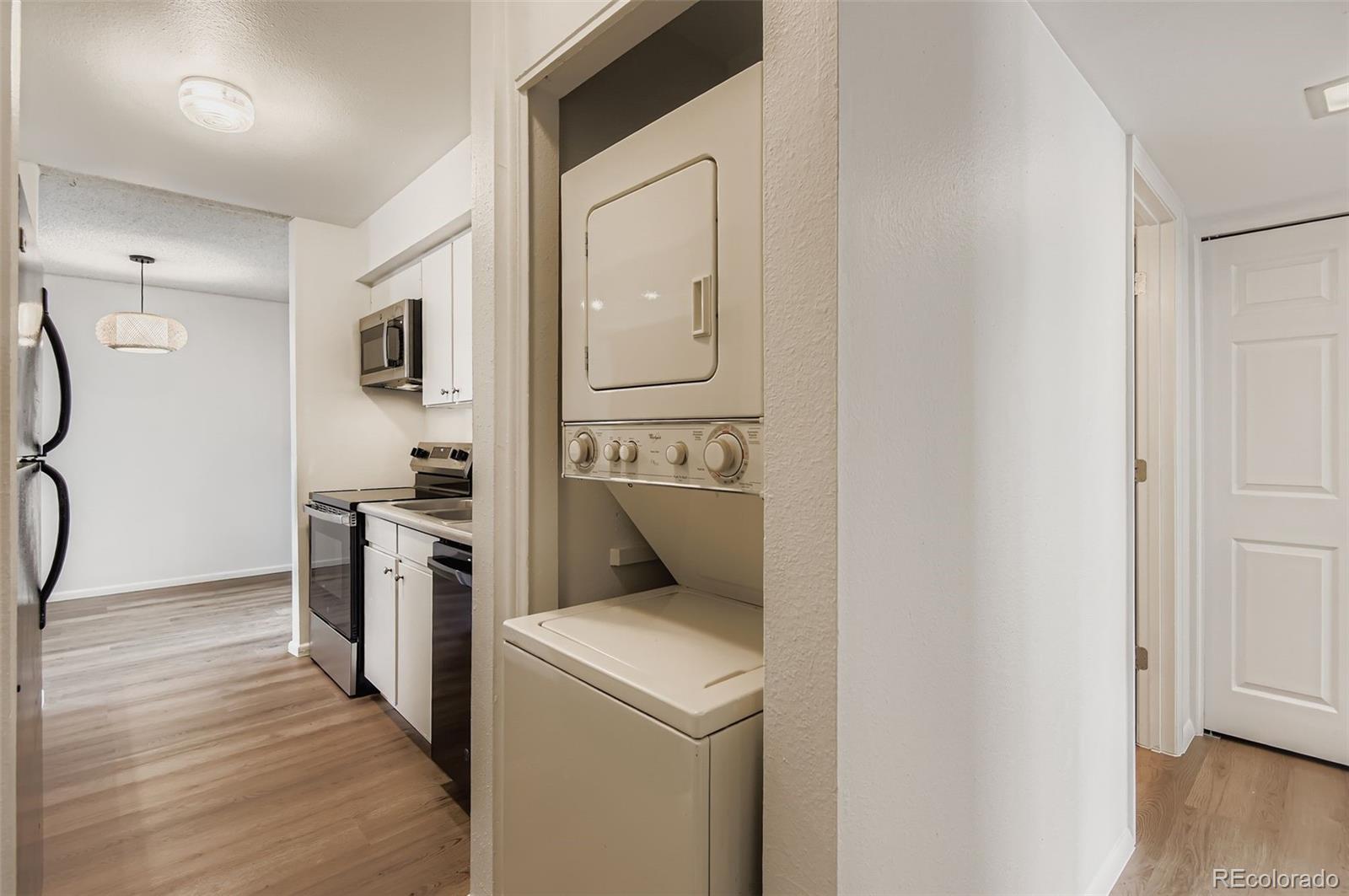 3323 South Monaco Street, Unit D Denver, CO 80222 - Photo 14 of 27 a kitchen with a refrigerator and a stove top oven