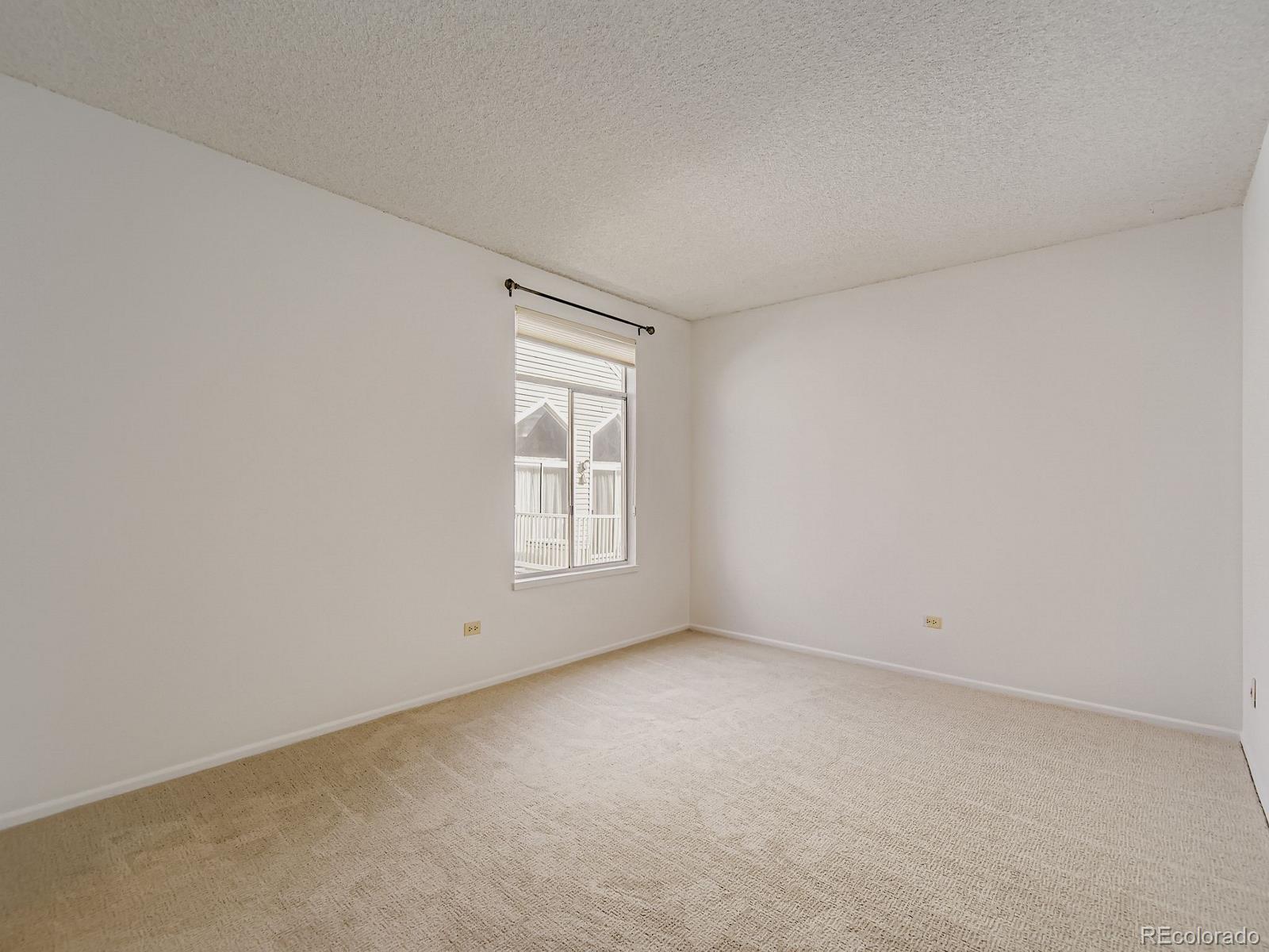 3323 South Monaco Street, Unit D Denver, CO 80222 - Photo 16 of 27 an empty room with a window