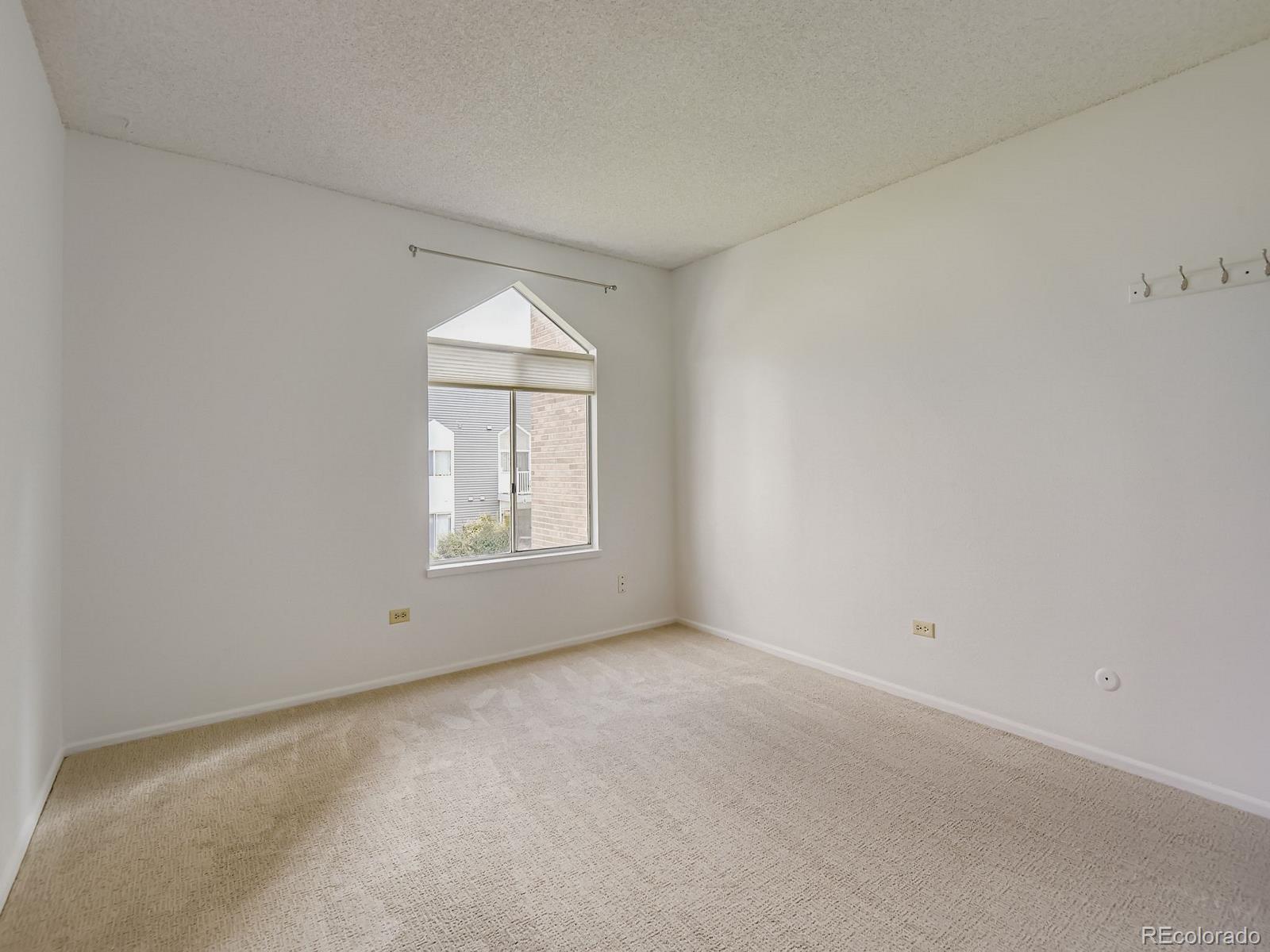 3323 South Monaco Street, Unit D Denver, CO 80222 - Photo 19 of 27 an empty room with a window
