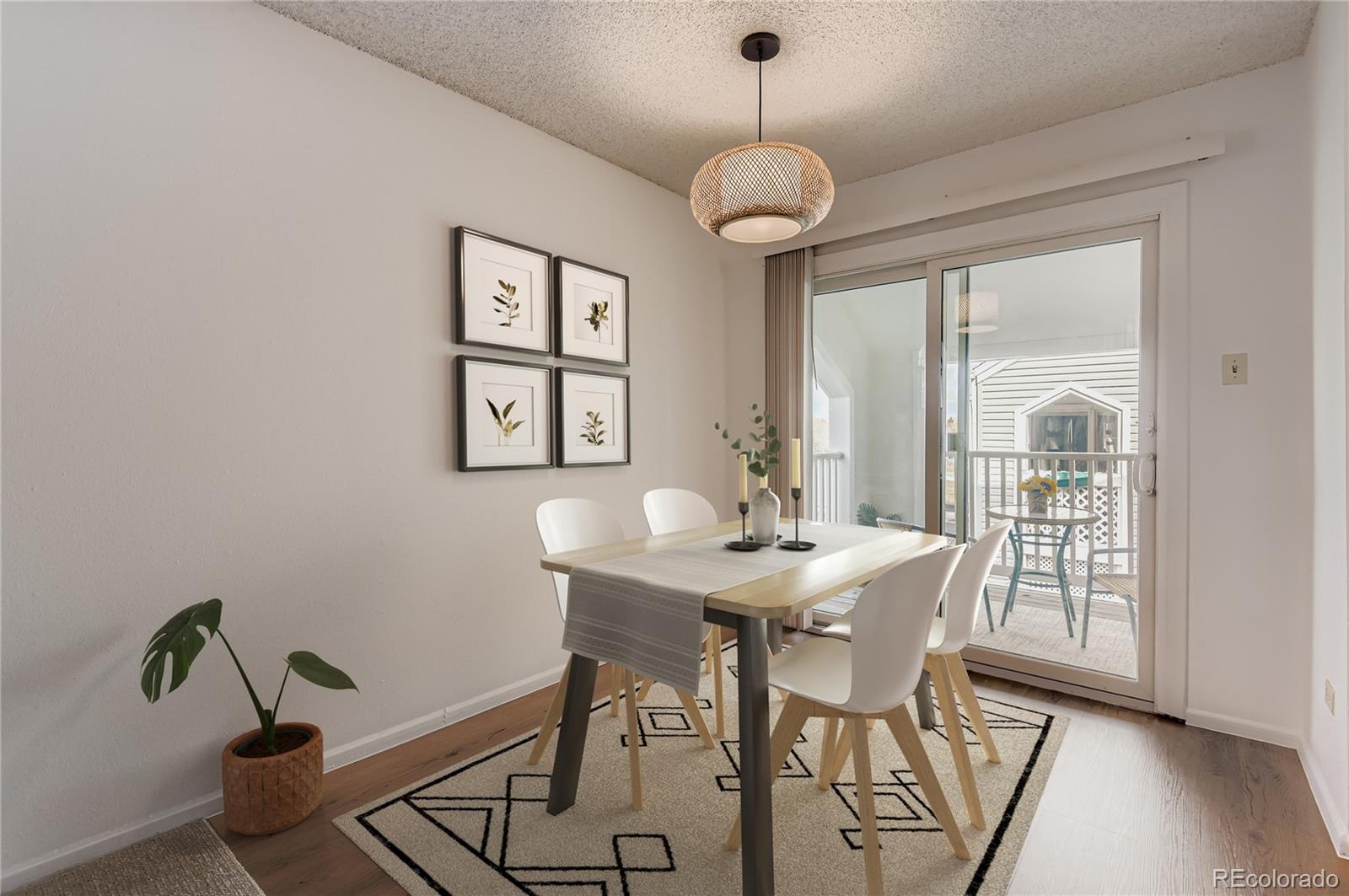 3323 South Monaco Street, Unit D Denver, CO 80222 - Photo 2 of 27 a view of a dining room with furniture window and wooden floor