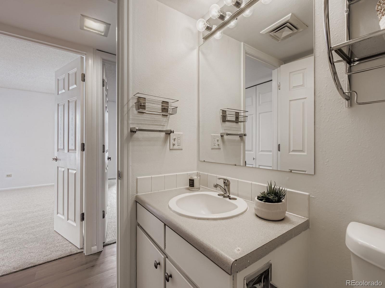 3323 South Monaco Street, Unit D Denver, CO 80222 - Photo 22 of 27 a bathroom with a sink and a mirror