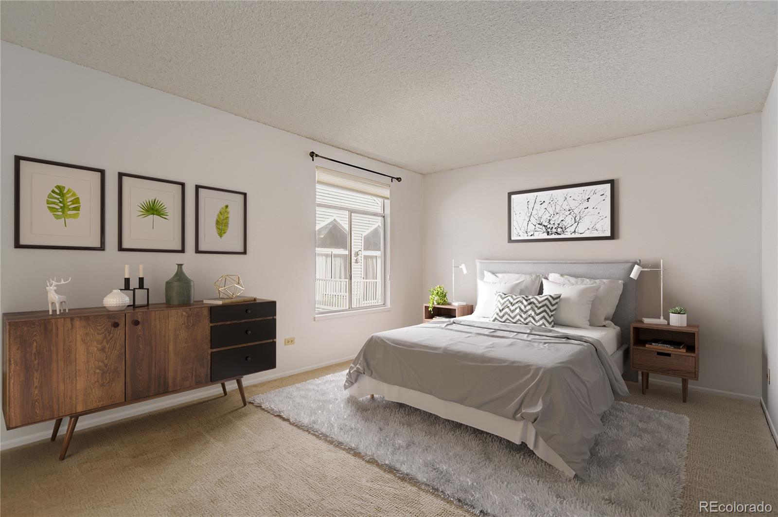 3323 South Monaco Street, Unit D Denver, CO 80222 - Photo 3 of 27 a bedroom with a bed and a desk