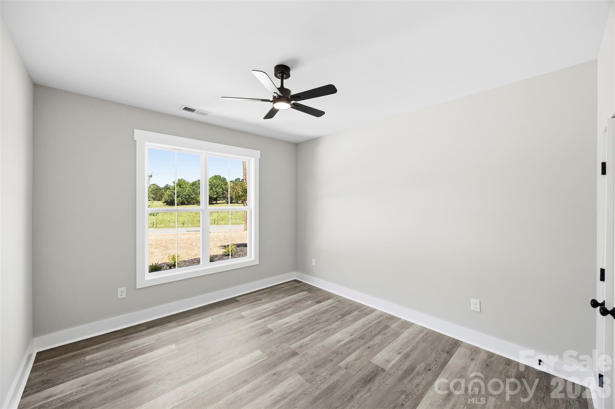 1014 Speight Road Albemarle, NC 28001 - Photo 18 of 28 a view of empty room with wooden floor and fan