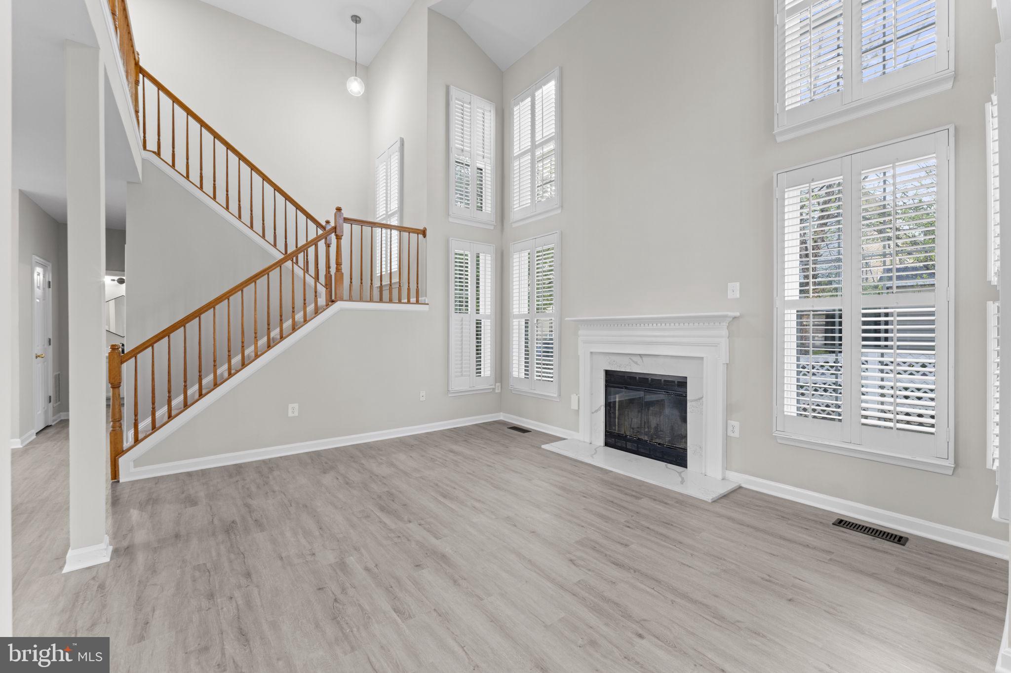 17549 Tedler Circle Round Hill, VA 20141 - Photo 11 of 71 a view of an empty room with wooden floor fireplace and a window