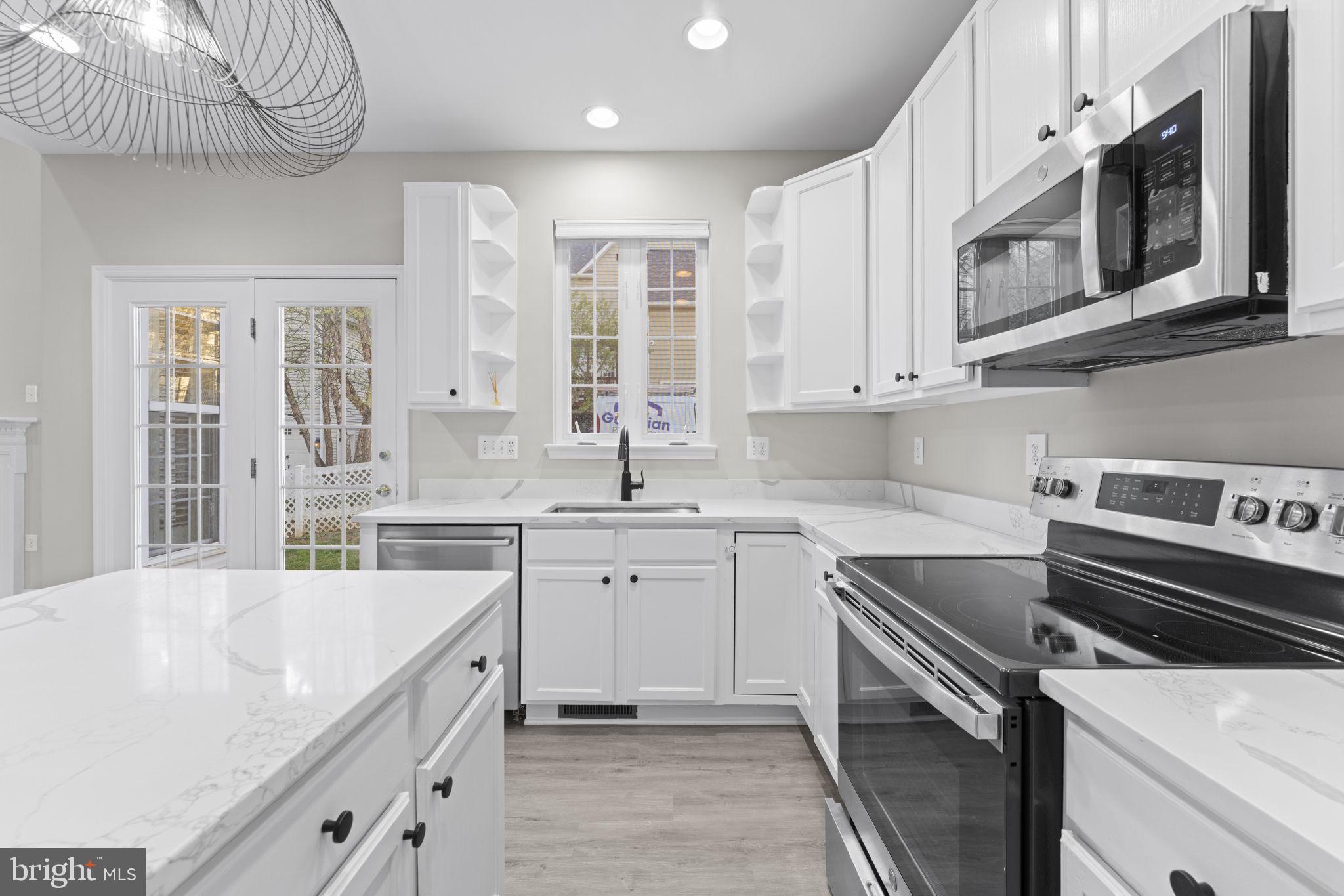 17549 Tedler Circle Round Hill, VA 20141 - Photo 15 of 71 a kitchen with stainless steel appliances a sink a stove and cabinets