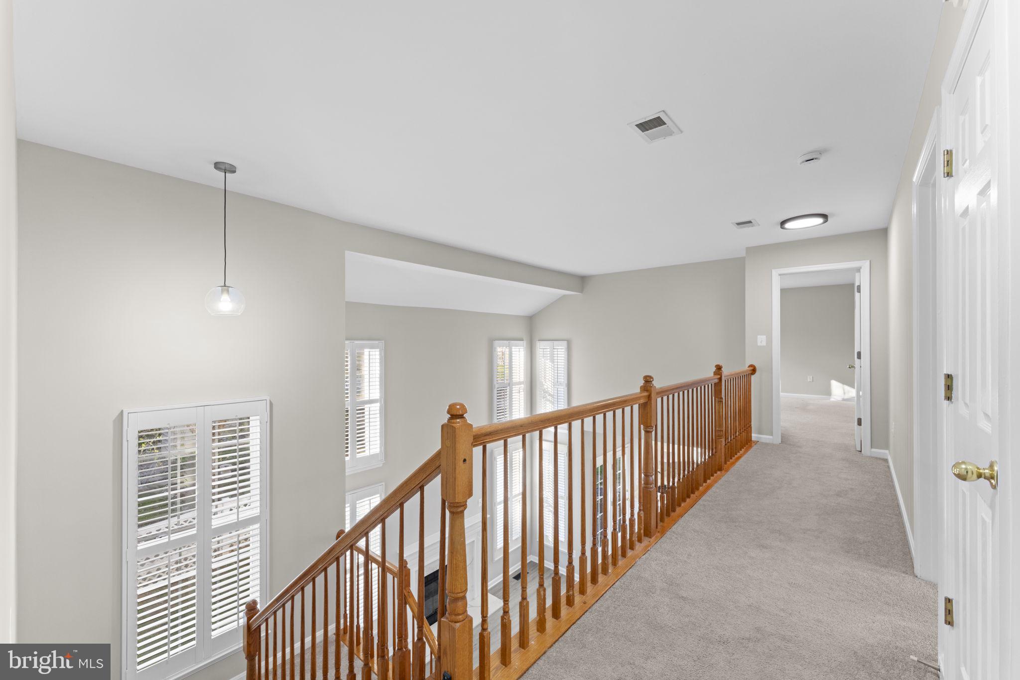 17549 Tedler Circle Round Hill, VA 20141 - Photo 20 of 71 a view of a hallway with wooden floor and windows