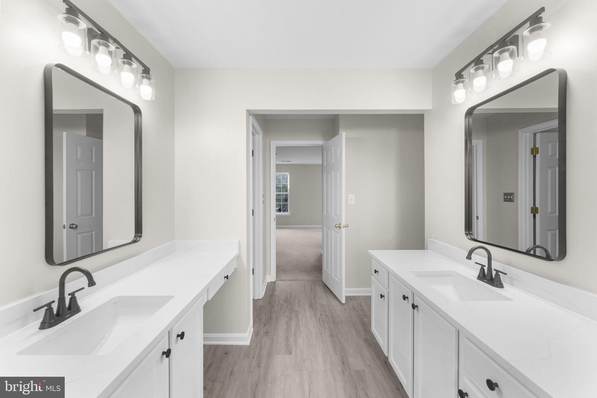 17549 Tedler Circle Round Hill, VA 20141 - Photo 27 of 71 a bathroom with double vanity sinks and a mirror
