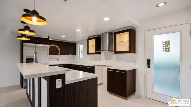 a kitchen with a sink a counter space and stainless steel appliances