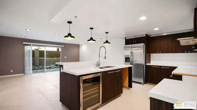 a kitchen that has a sink and a stove in it