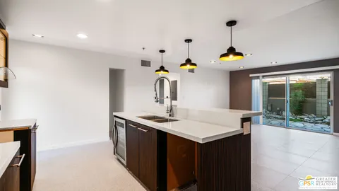 a kitchen with a sink a counter top space and appliances