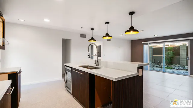 a kitchen with a sink a counter top space and appliances