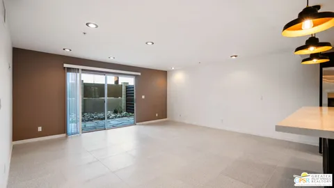 a view of a room with a window and ceiling fan