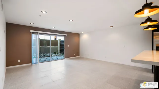 a view of a room with a window and ceiling fan