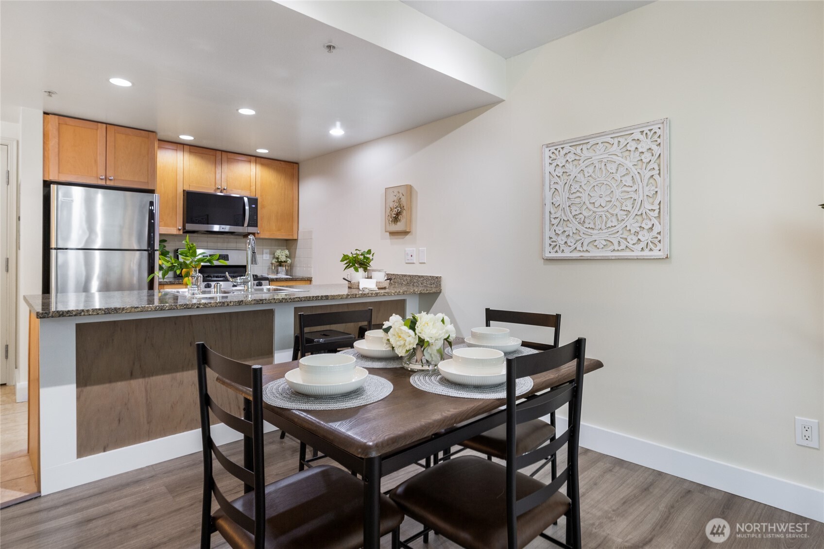 1420 Terry Avenue, Unit 607 Seattle, WA 98101 - Photo 11 of 40 a kitchen with a table and chairs in it