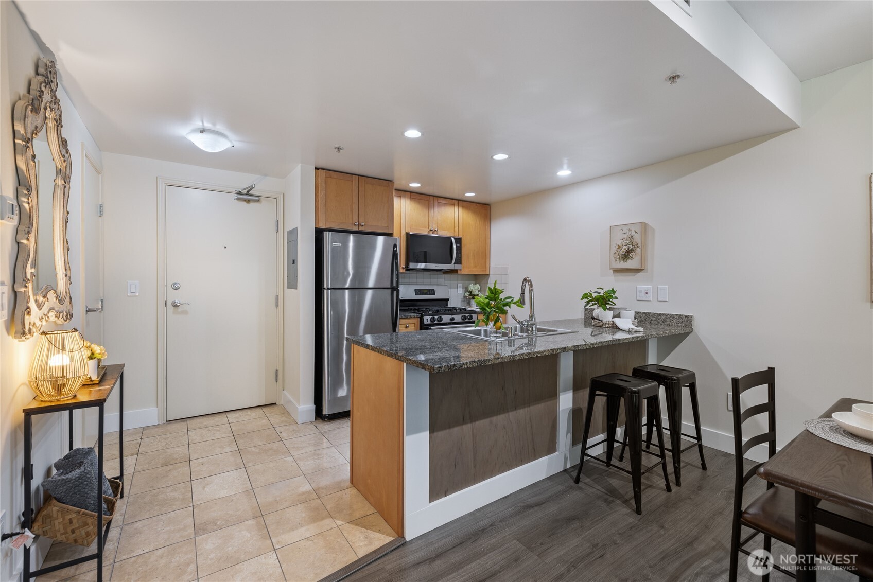 1420 Terry Avenue, Unit 607 Seattle, WA 98101 - Photo 13 of 40 a kitchen with stainless steel appliances granite countertop a refrigerator and a stove top oven