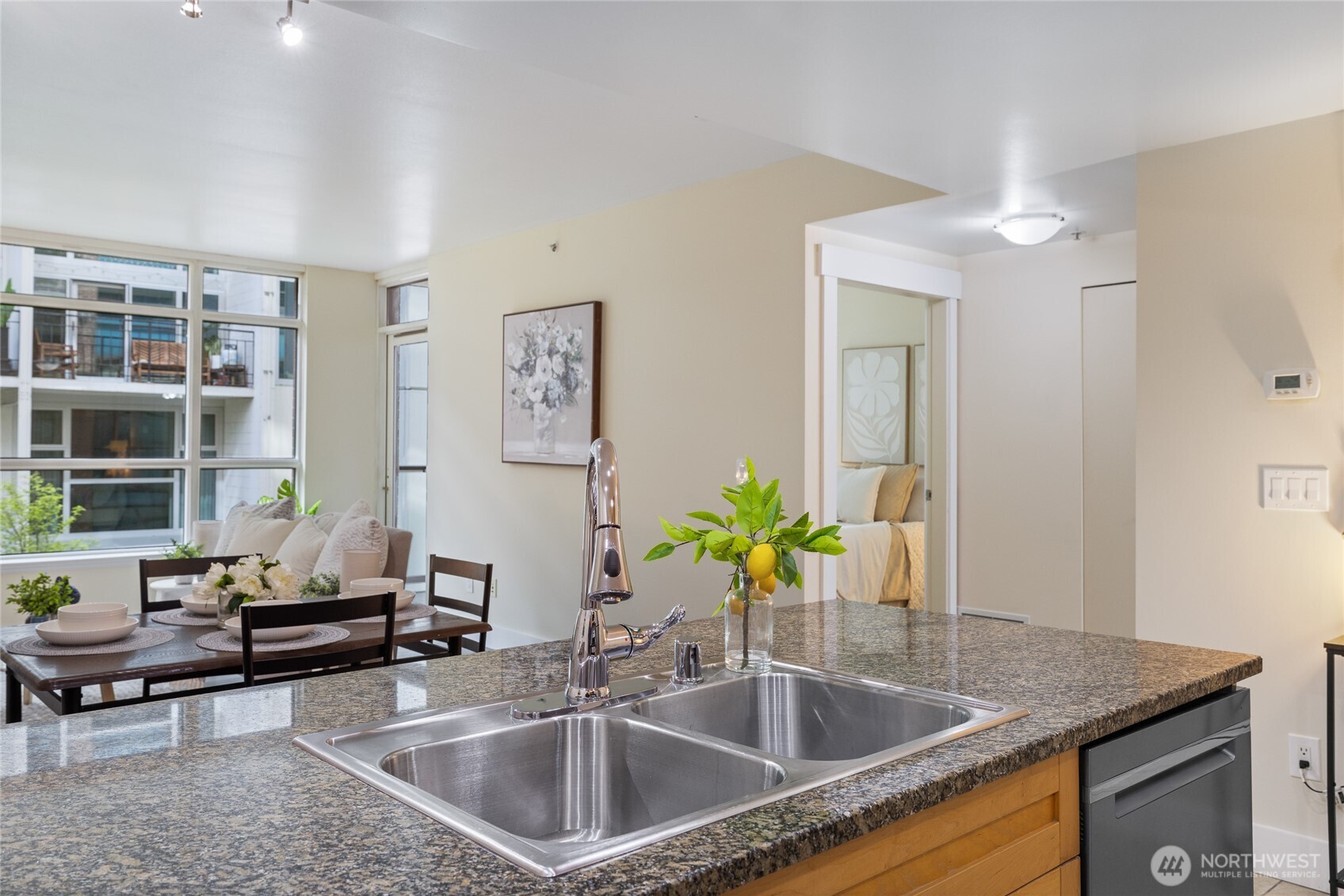 1420 Terry Avenue, Unit 607 Seattle, WA 98101 - Photo 16 of 40 a kitchen with a sink a counter and chairs